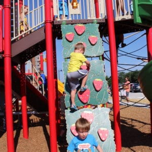 Thumbnail of Children climbing up a wall decorated with strawberry climbers