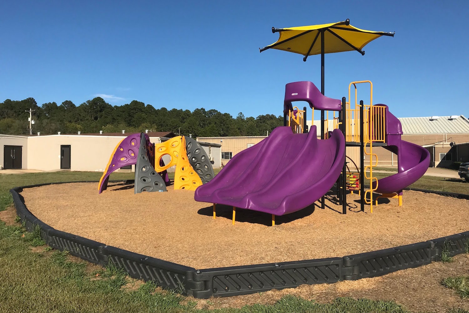 Purple and yellow slides and shade at Winona Elementary School