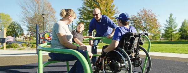 family playing on inclusive playground