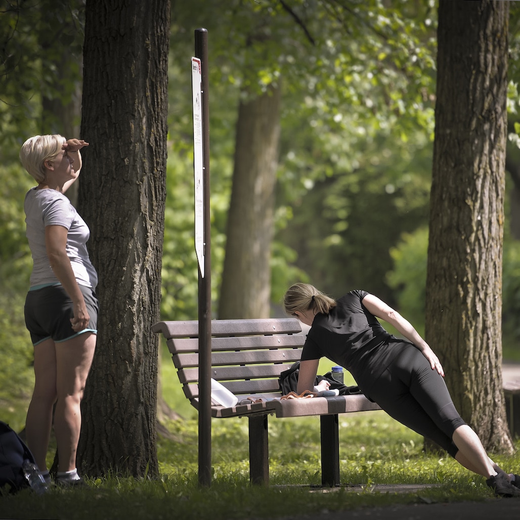 Two people working out at a park.