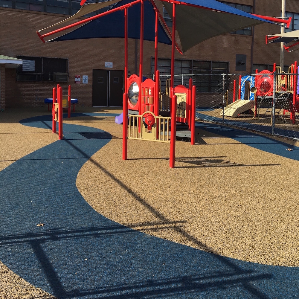 Poured in place rubber swirled navy and tan on a school playground