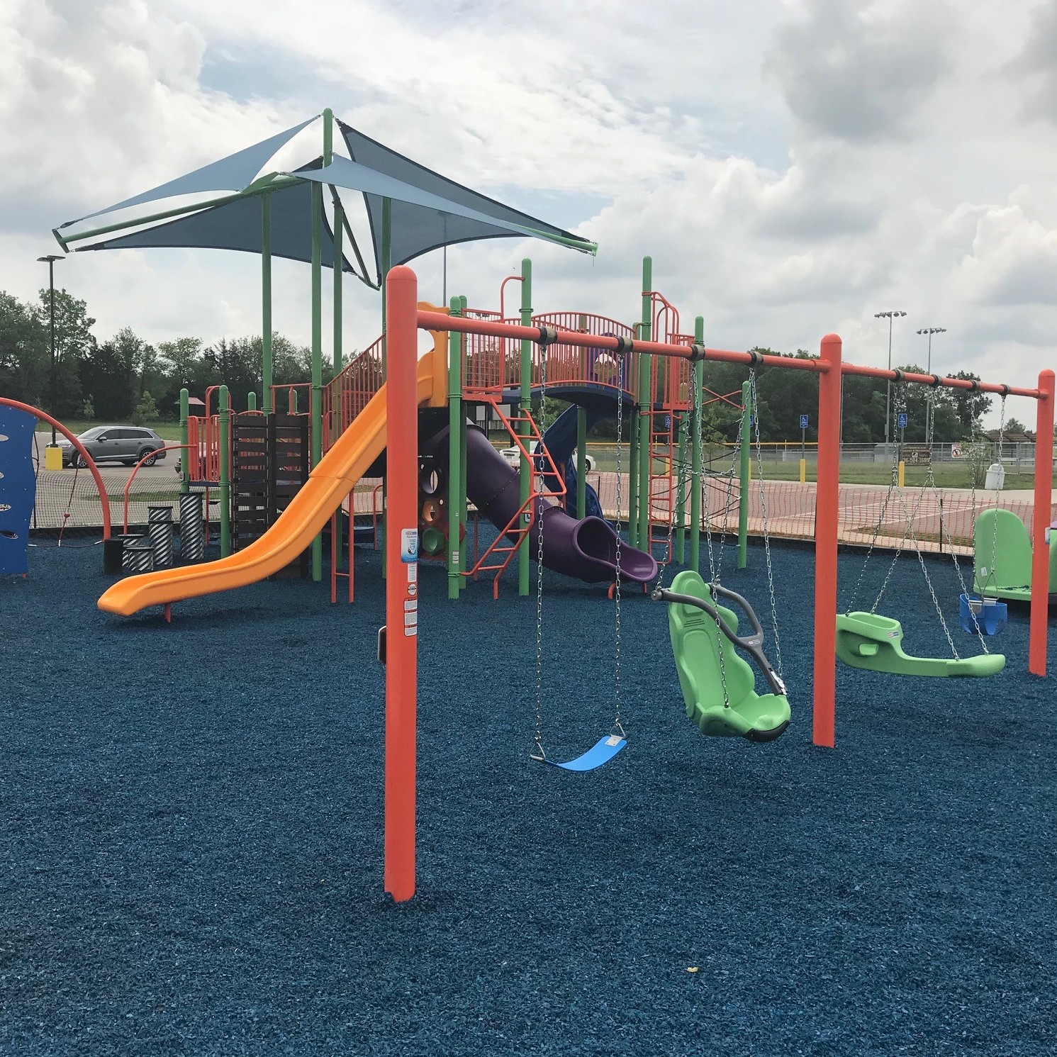 Blue rubber mulch safety surface on a playground.