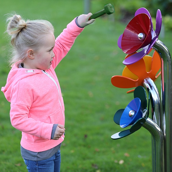 Small child making music with harmony flowers