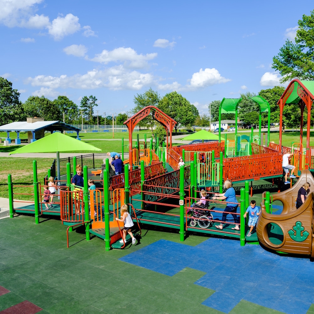 People playing on a brightly colored n inclusive playground